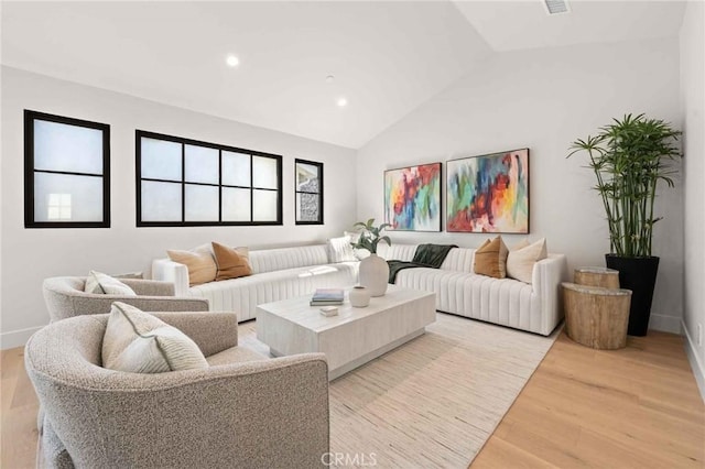 living area featuring recessed lighting, baseboards, lofted ceiling, and light wood-style floors