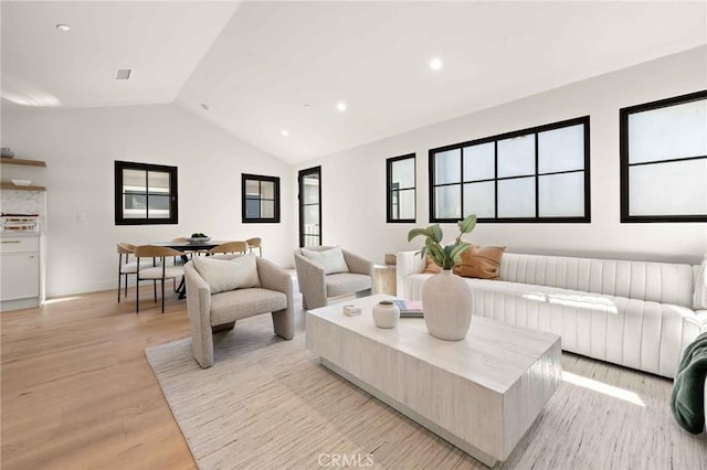 living room featuring light wood-style floors, recessed lighting, lofted ceiling, and visible vents