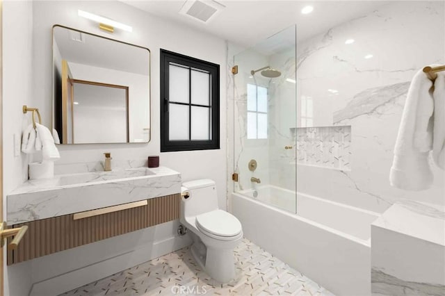 bathroom with vanity, visible vents, marble finish floor, bathing tub / shower combination, and toilet