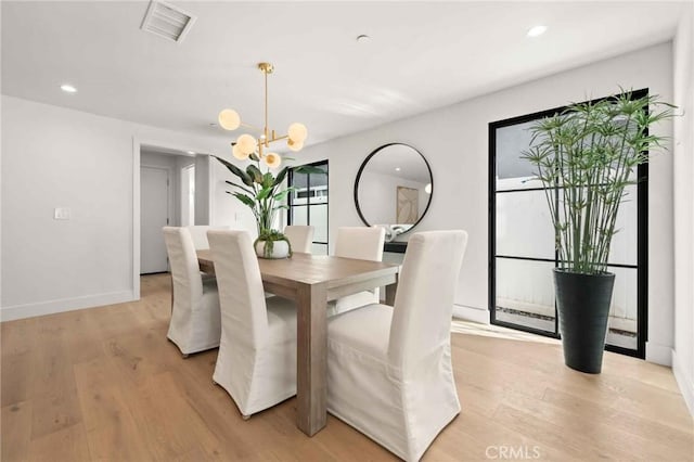 dining room featuring recessed lighting, a notable chandelier, light wood-type flooring, and visible vents