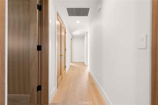 hall with recessed lighting, baseboards, visible vents, and light wood finished floors
