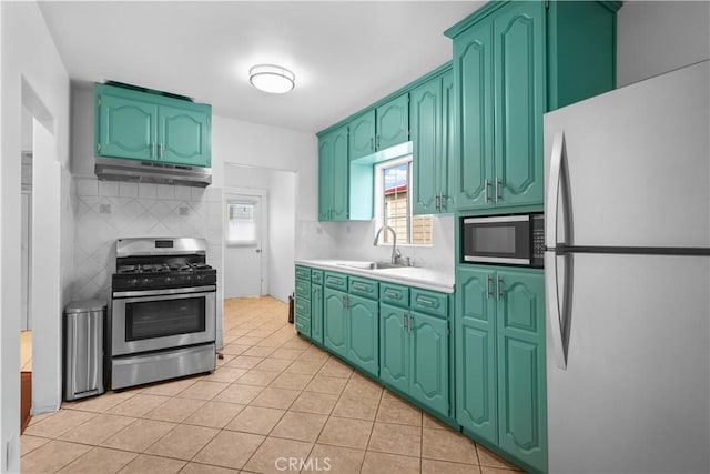 kitchen featuring stainless steel appliances, backsplash, under cabinet range hood, and light countertops