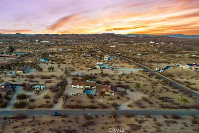 bird's eye view featuring a mountain view, a desert view, and a rural view