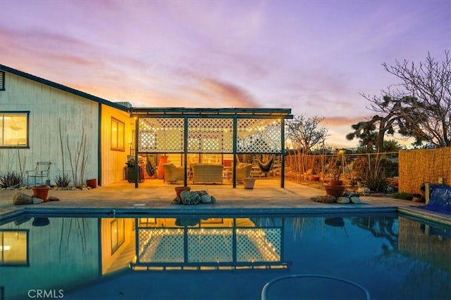 pool at dusk featuring fence and a fenced in pool