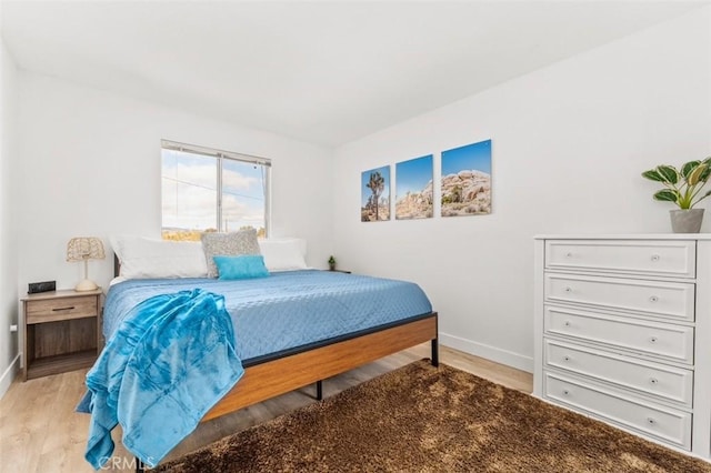bedroom featuring light wood-style flooring and baseboards