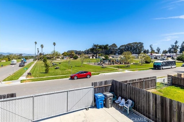 view of property's community featuring fence and a mountain view