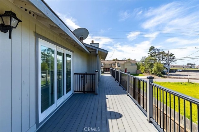 wooden terrace featuring a yard