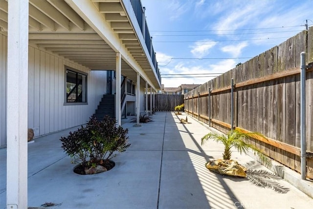 view of side of home featuring a patio area and a fenced backyard