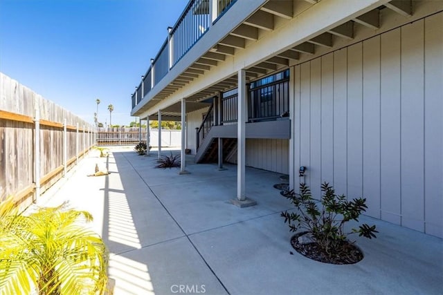 view of patio / terrace featuring a fenced backyard and a balcony