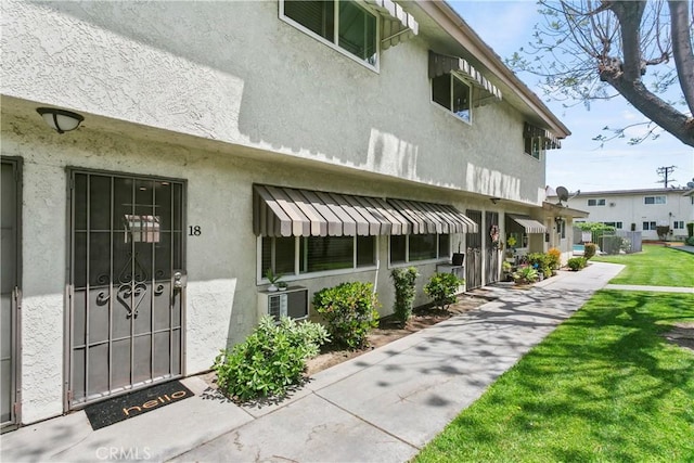 5593 Pioneer Blvd Unit 18, Whittier, CA 90601 - doorway to property featuring stucco siding and a lawn