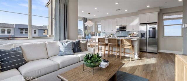 302 Fawn St, Rancho Mission Viejo, CA 92694 - living room with recessed lighting, light wood-style flooring, and baseboards