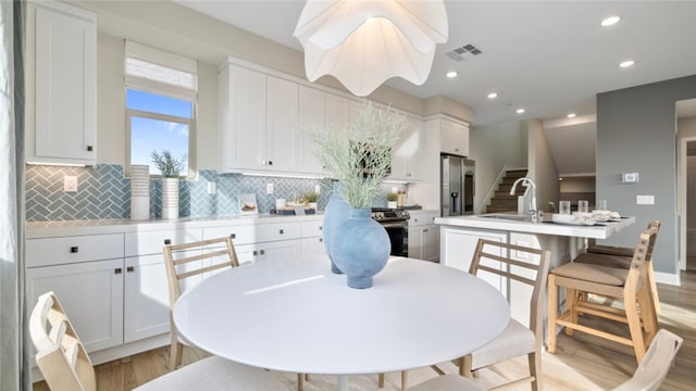 302 Fawn St, Rancho Mission Viejo, CA 92694 - dining room featuring light wood finished floors, stairs, visible vents, and recessed lighting