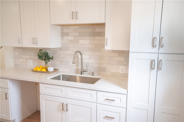 6022 Camerino, Lakewood, CA 90713 - kitchen featuring a sink, white cabinetry, and tasteful backsplash