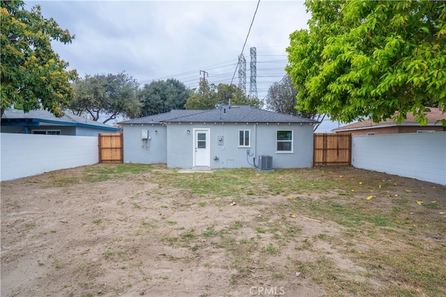 6022 Camerino, Lakewood, CA 90713 - back of house with cooling unit, stucco siding, and a fenced backyard