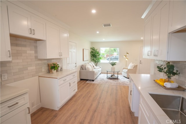 6022 Camerino, Lakewood, CA 90713 - kitchen featuring open floor plan, light countertops, white cabinets, light wood finished floors, and recessed lighting