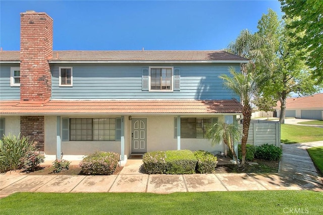 28 Dearborn Cir, Redlands, CA 92374 - view of front of house with a tiled roof, stucco siding, and a front lawn