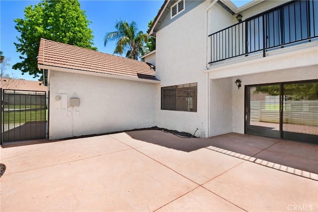 28 Dearborn Cir, Redlands, CA 92374 - view of patio / terrace with a balcony and a gate