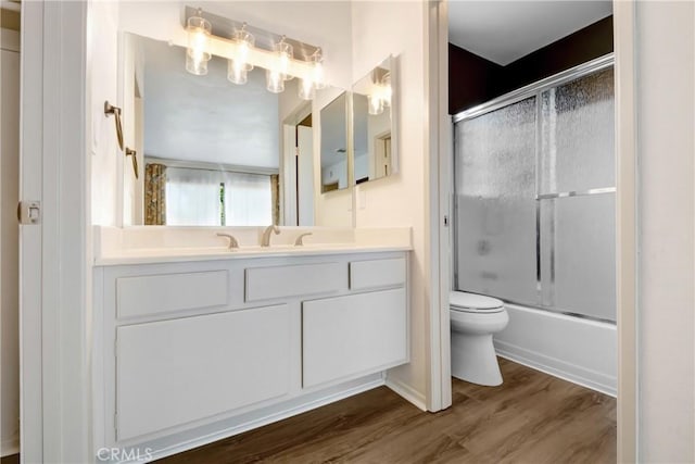 28 Dearborn Cir, Redlands, CA 92374 - bathroom featuring toilet, vanity, bath / shower combo with glass door, and wood finished floors
