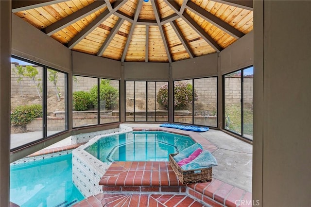 view of swimming pool with an indoor hot tub