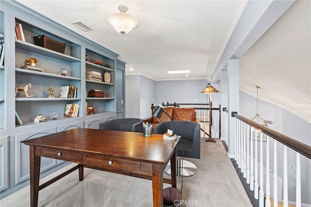 carpeted office space featuring visible vents and crown molding