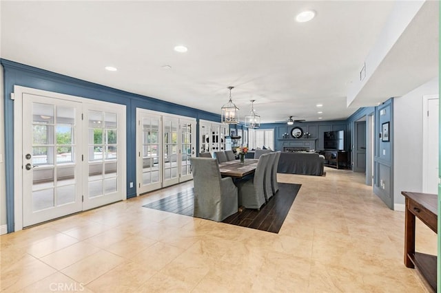 dining area featuring a fireplace, a wealth of natural light, french doors, and recessed lighting