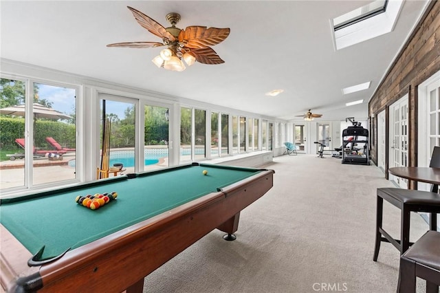playroom with ceiling fan, carpet floors, and a skylight
