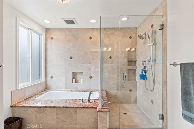 full bathroom featuring a garden tub, visible vents, and a stall shower