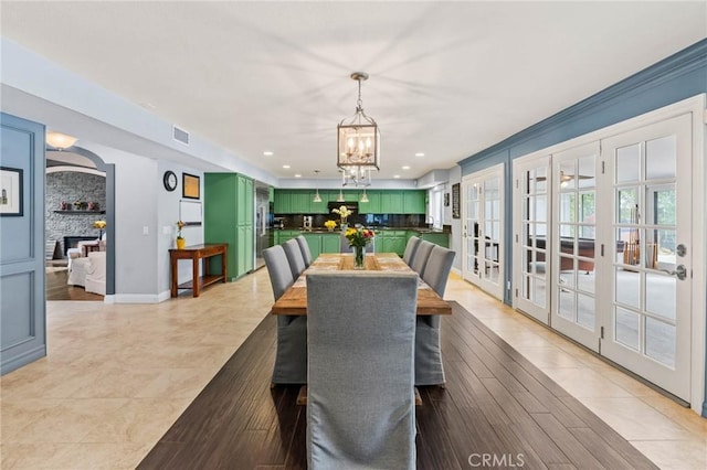 dining space with french doors, visible vents, recessed lighting, a chandelier, and light tile patterned floors