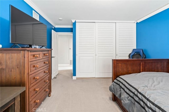 bedroom featuring light carpet, ornamental molding, and a closet