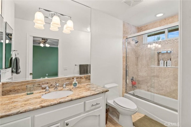 bathroom with tile patterned floors, vanity, ceiling fan, enclosed tub / shower combo, and toilet