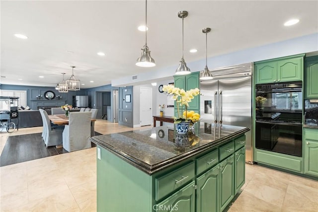 kitchen featuring recessed lighting, green cabinetry, dobule oven black, a chandelier, and stainless steel built in refrigerator