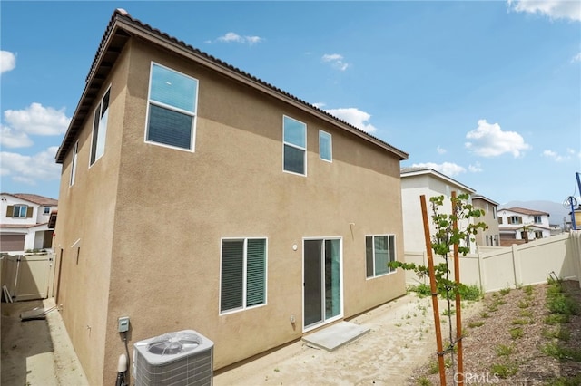 2070 Zest St, Redlands, CA 92374 - rear view of house featuring central air condition unit, stucco siding, a fenced backyard, and a residential view