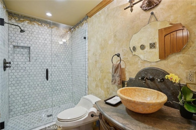 full bath with toilet, vanity, and a stall shower