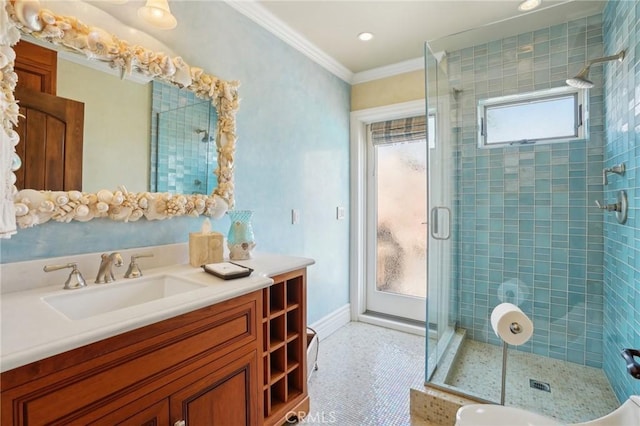 bathroom with a stall shower, baseboards, recessed lighting, crown molding, and vanity