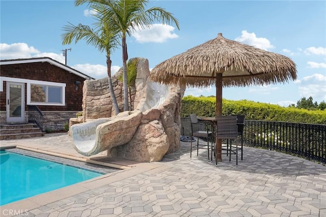 view of pool with a fenced in pool, a patio, entry steps, and fence