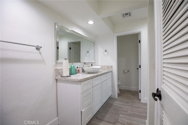 73640 Joshua Tree St, Palm Desert, CA 92260 - bathroom featuring vanity, baseboards, toilet, visible vents, and recessed lighting