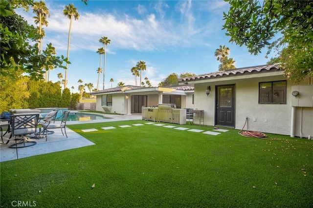 73640 Joshua Tree St, Palm Desert, CA 92260 - back of property featuring a patio area, a lawn, an outdoor pool, and stucco siding