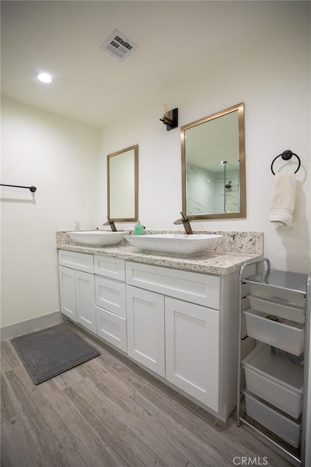 73640 Joshua Tree St, Palm Desert, CA 92260 - full bathroom with wood finished floors, visible vents, a sink, and double vanity
