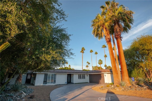 73640 Joshua Tree St, Palm Desert, CA 92260 - ranch-style house with an attached garage, a tile roof, driveway, and stucco siding
