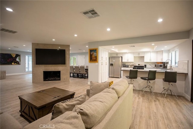 73640 Joshua Tree St, Palm Desert, CA 92260 - living area with light wood-type flooring, visible vents, and recessed lighting