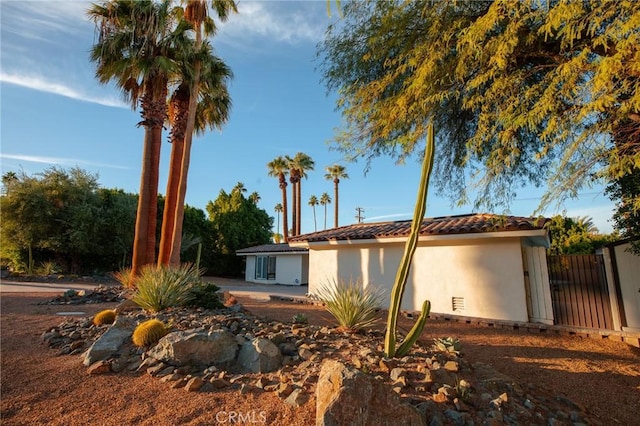 73640 Joshua Tree St, Palm Desert, CA 92260 - exterior space with stucco siding, fence, and a tiled roof