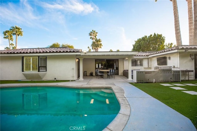 73640 Joshua Tree St, Palm Desert, CA 92260 - rear view of house with exterior kitchen, a tiled roof, stucco siding, a patio, and a lawn