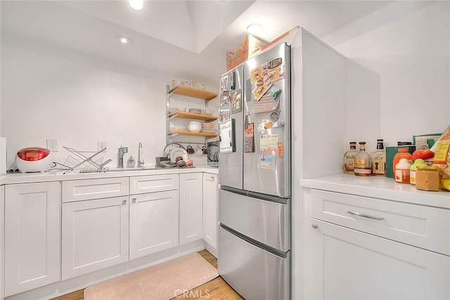 686 E Workman St, Covina, CA 91723 - kitchen with recessed lighting, freestanding refrigerator, light countertops, white cabinets, and light wood-style floors