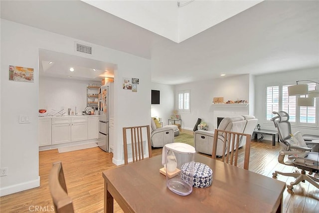 686 E Workman St, Covina, CA 91723 - dining space with light wood finished floors, baseboards, a fireplace, and recessed lighting