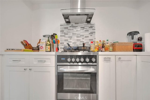 686 E Workman St, Covina, CA 91723 - kitchen with gas stove, white cabinets, backsplash, light countertops, and stainless steel oven