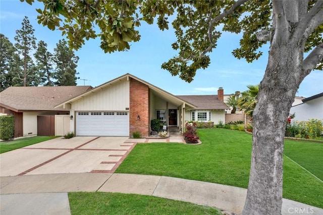 mid-century home with a front lawn, a garage, brick siding, a chimney, and concrete driveway