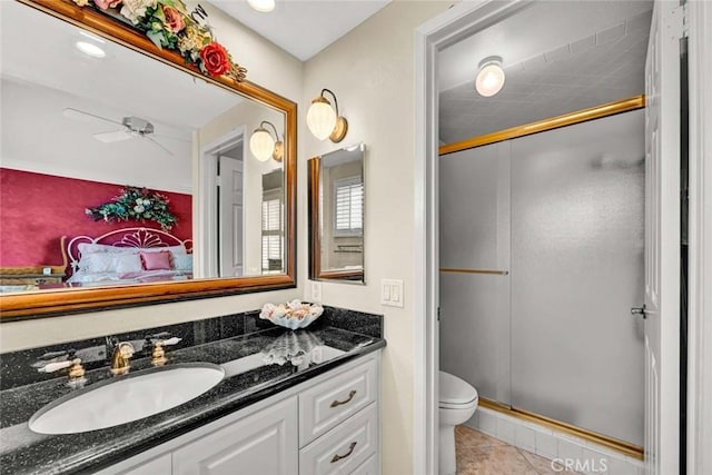 full bathroom with vanity, toilet, a stall shower, a ceiling fan, and tile patterned flooring