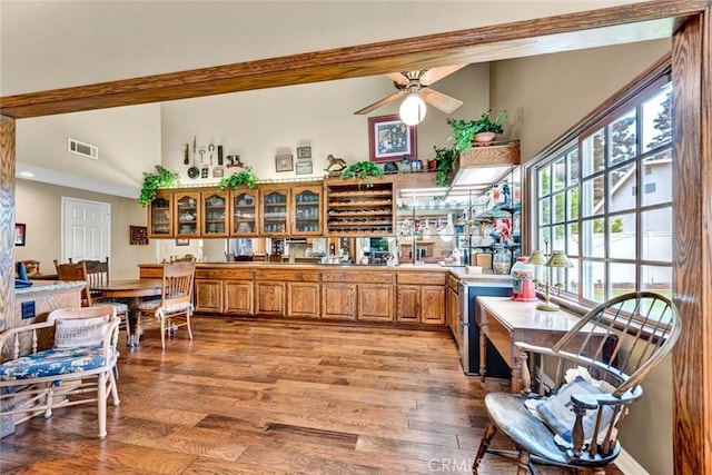 interior space with visible vents, plenty of natural light, brown cabinetry, and light wood-style floors