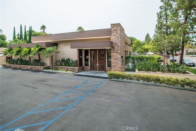 view of front of home featuring stucco siding and stone siding