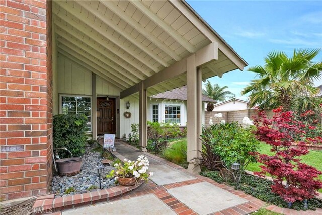 doorway to property with fence and brick siding